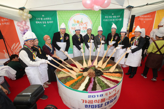 25일 농협하나로마트 양재점 야외 특설매장에서 개최된 '2018년 우리쌀 가공식품·전통주 한마당 대축제'에서 김병원 농협중앙회 회장(사진 왼쪽부터 다섯번째)과 참석자들이 비빔밥 퍼포먼스를 하고 있다. 농협제공